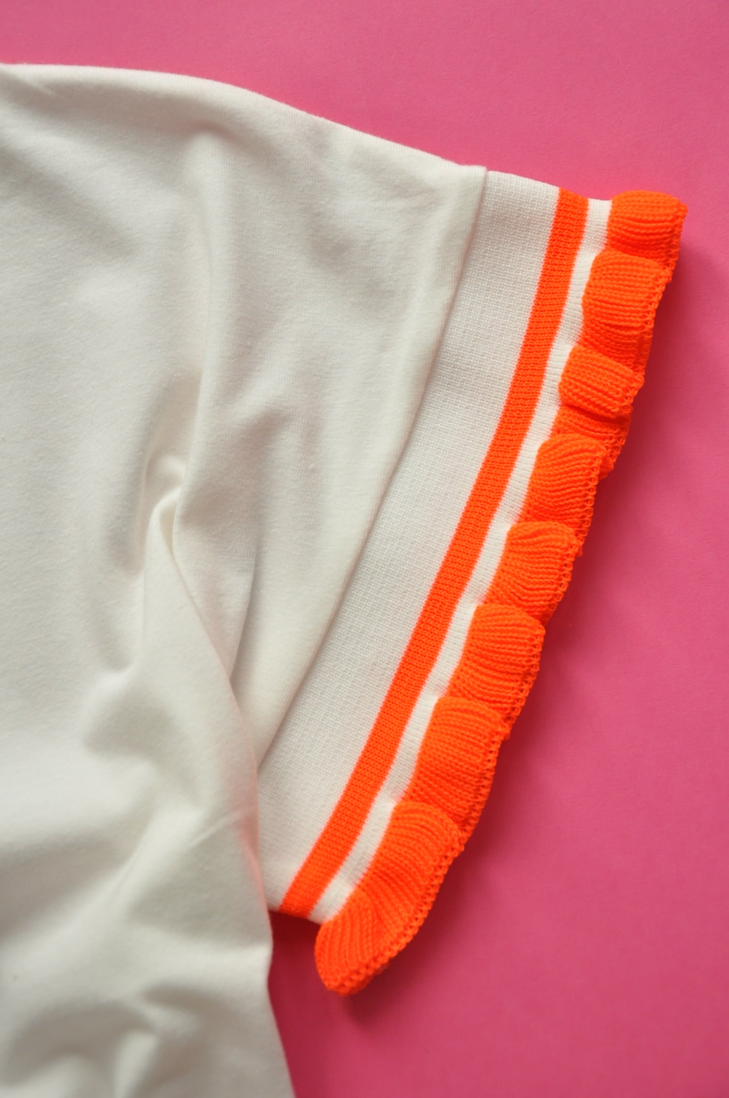 Cream soft cotton tee with neon orange knit frill sleeves