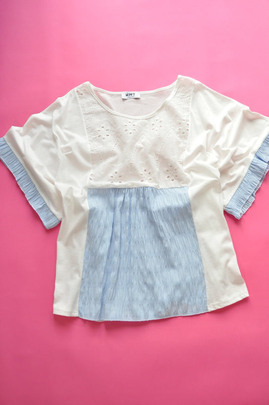 White oversized t-shirt with elasticated blue check and frilled batwing sleeves