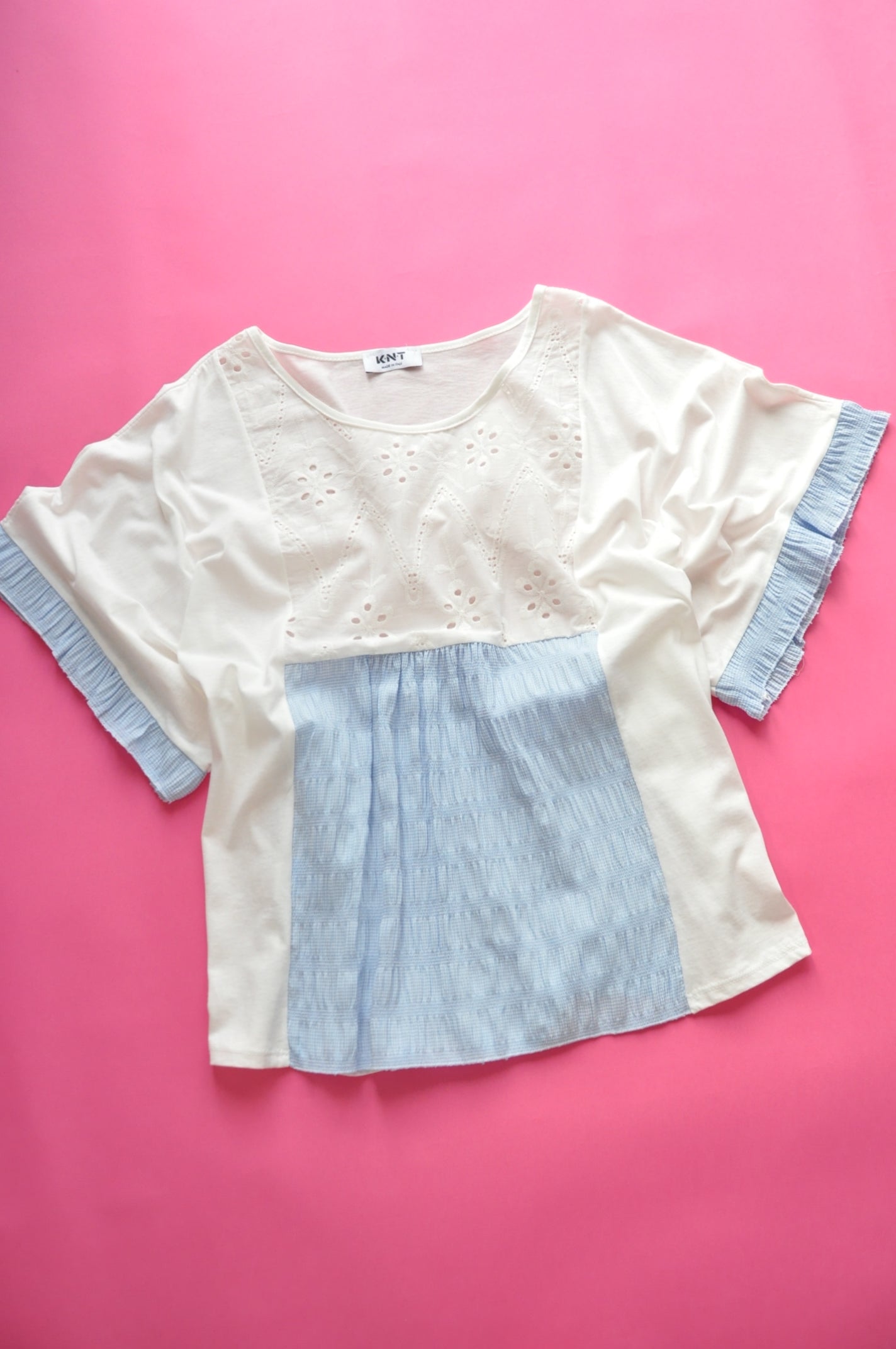 White oversized t-shirt with elasticated blue check and frilled batwing sleeves