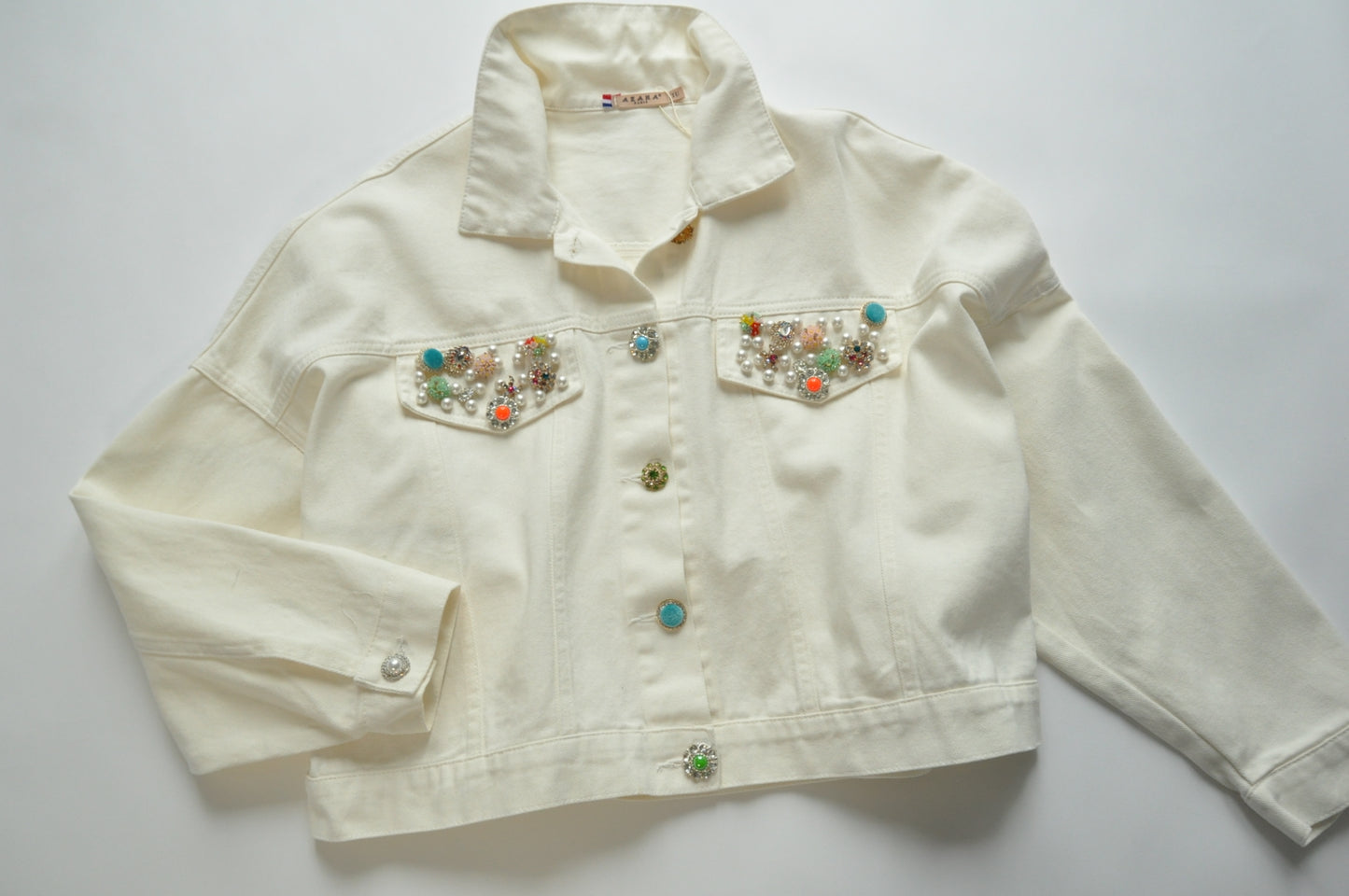 Embellished-button cropped cream denim jacket