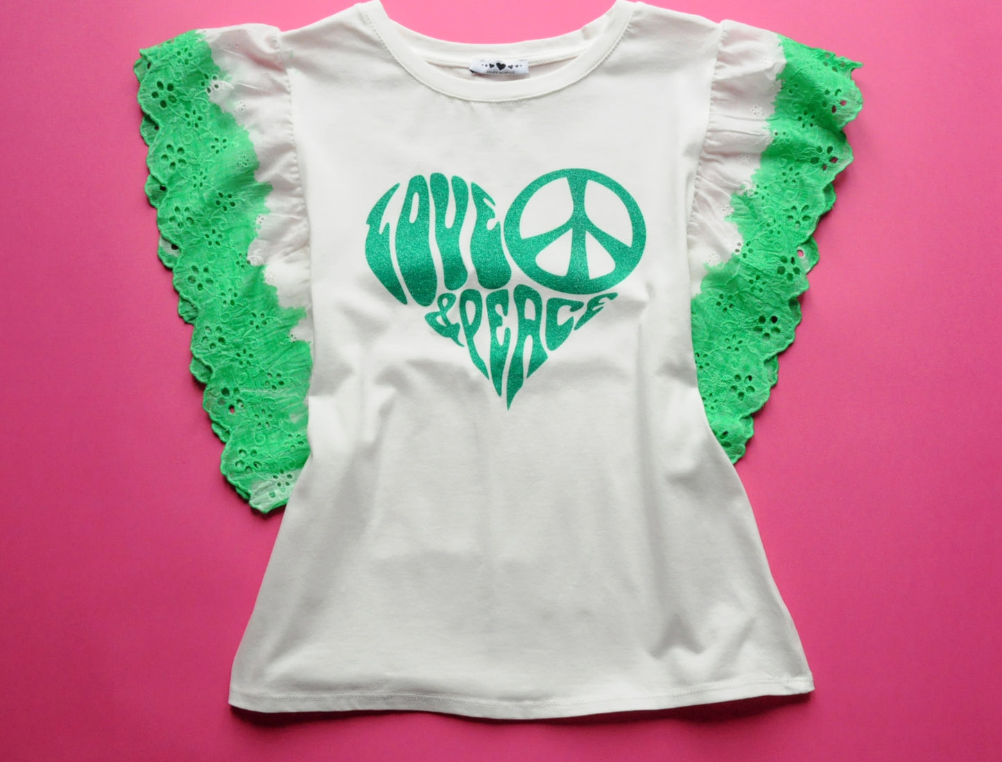 White straight-cut t-shirt with brocade green heart detail and frilled sleeves