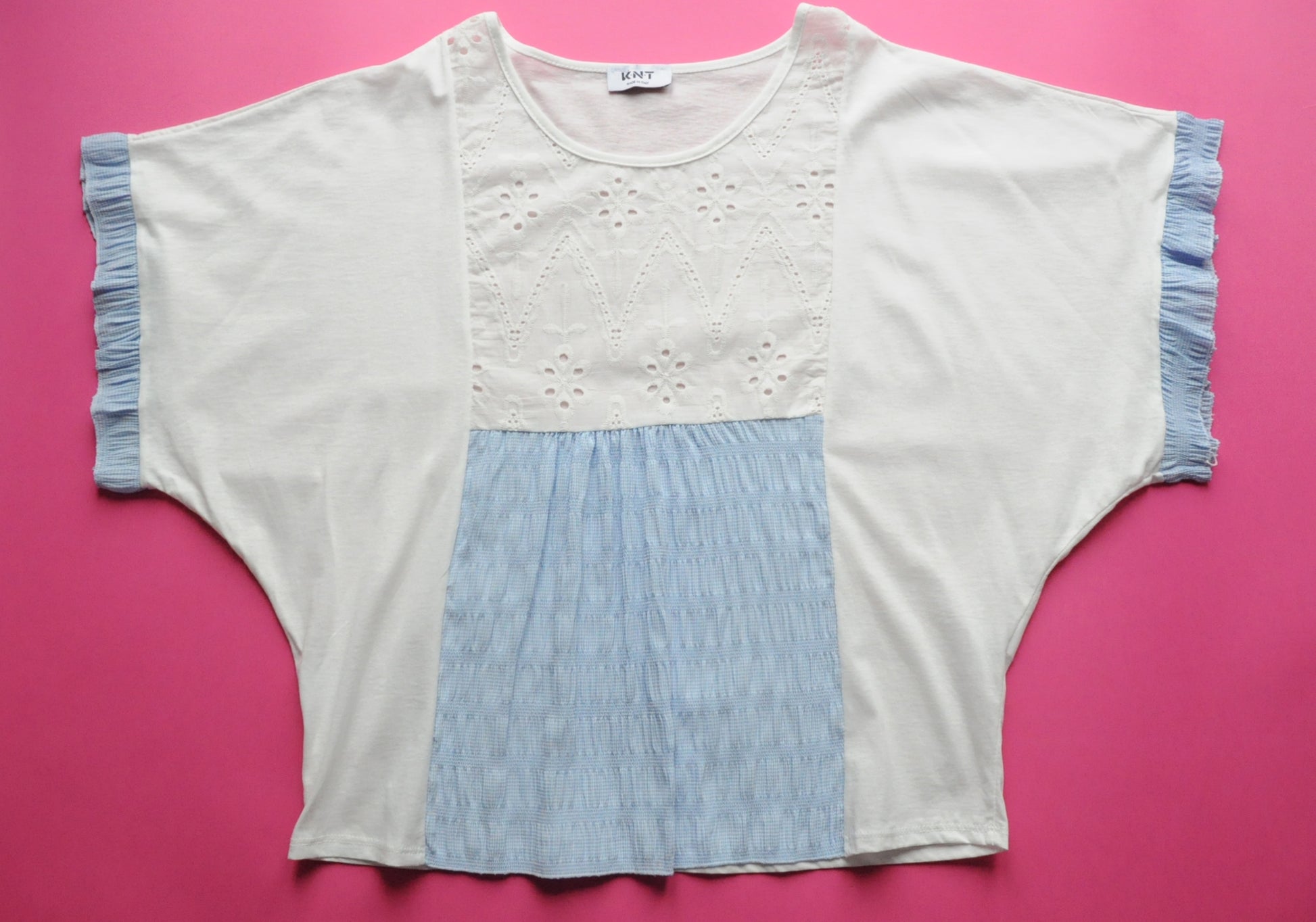 White oversized t-shirt with elasticated blue check and frilled batwing sleeves