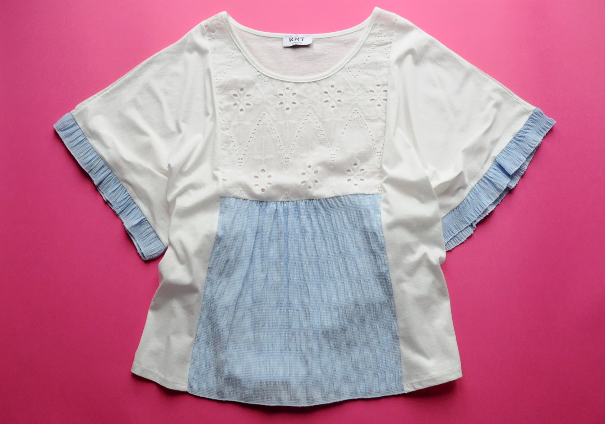 White oversized t-shirt with elasticated blue check and frilled batwing sleeves